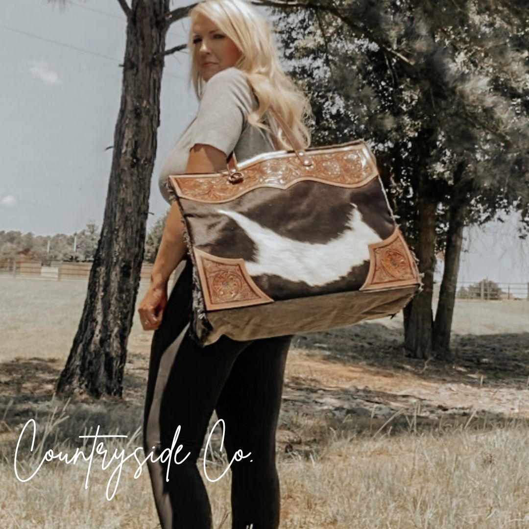 Cowhide on sale weekender bag