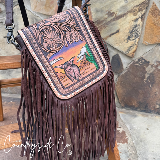Brown leather handbag with fringe and cowboy desig