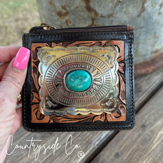 Hand tooled leather wallet with decorative concho featuring a turquoise stone